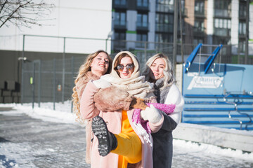 Three beautiful Russian girls are having fun on the street