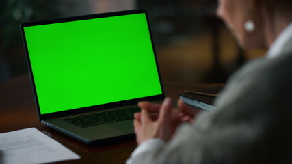 Unrecognizable elderly woman having web conference at mockup computer at home