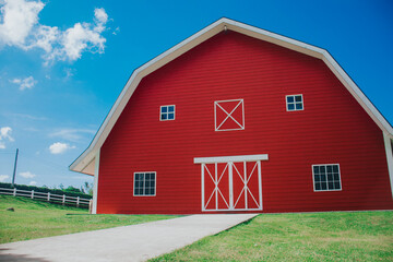 Fototapeta na wymiar Huge red barn on a clear sky.