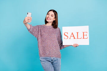 Photo of cheerful blogger lady hold phone sale placard take selfie wear pullover isolated blue...