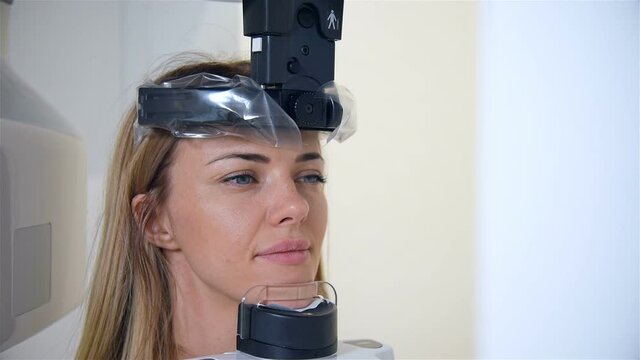Blonde Woman Having Panoramic X-ray Scanning Procedure In Clinic. Medicine, Dentistry And Healthcare Concept. Close Up