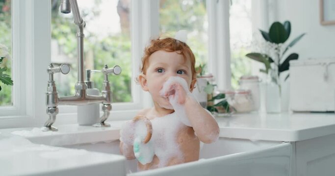 happy baby bathing funny toddler taking bath in kitchen sink having fun with soap bubbles 4k