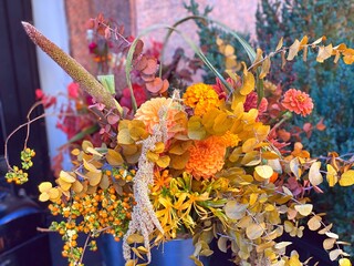 Autumn  bouquet of chrysanthemums, gerberas, zinnia, physalis, dry herbs, reed and tree leaves....