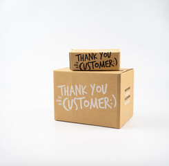 Two closed cardboard boxes taped up, and there is a Thank you for being our customer beside the parcel box for delivery and shopping online concept design isolated on white background.