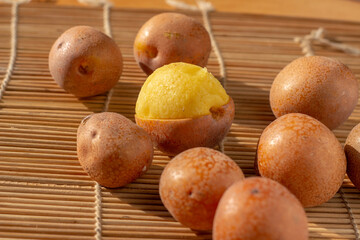 Peeled Parinari Curatellifolia fruits known as hacha or chakata revealing the yellow sweet pulp