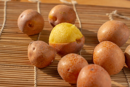 Peeled Parinari Curatellifolia fruits known as hacha or chakata revealing the yellow sweet pulp