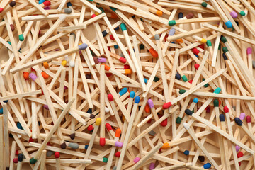 Matches with colorful heads as background, top view
