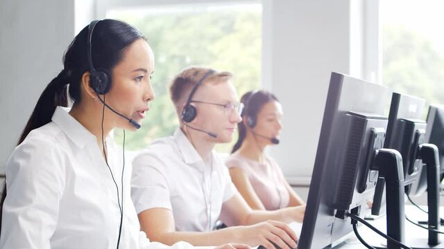 Diverse team of professionals is working in the phone support office. Working day of sales managers in the call center. Concept of business, telephone consulting and problem solving.