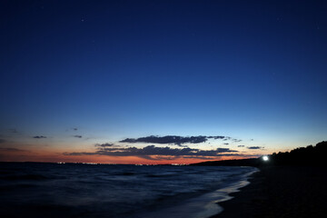 Picturesque view of beautiful sunset on seaside at night