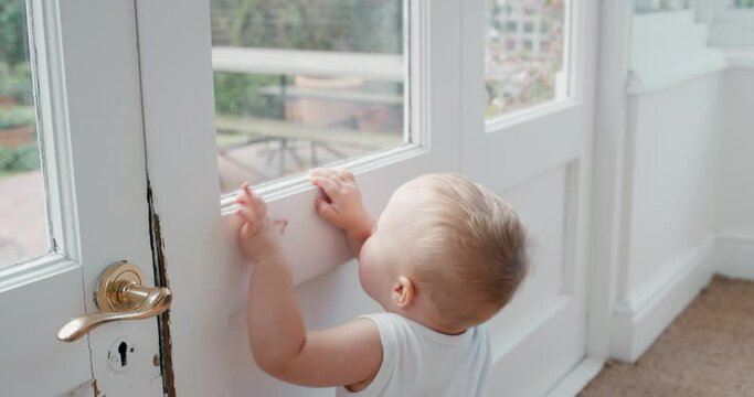 baby looking out window curious toddler learning to walk exploring home childhood development 4k footage