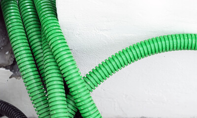 Corrugated tubular conduits ready to be filled with electrical cables on a construction site.