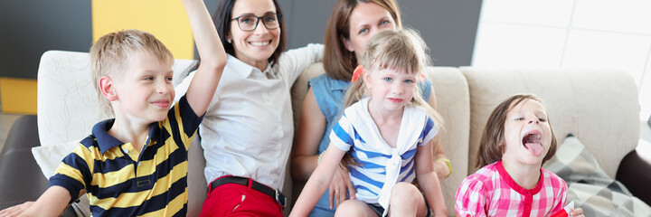 Lgbt family two women with joyful children hold flag