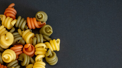 colorful pasta on black background