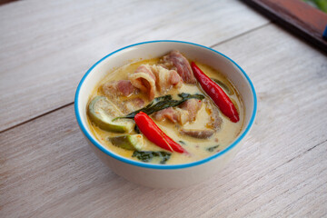Thai food  Pork green curry on wooden floor