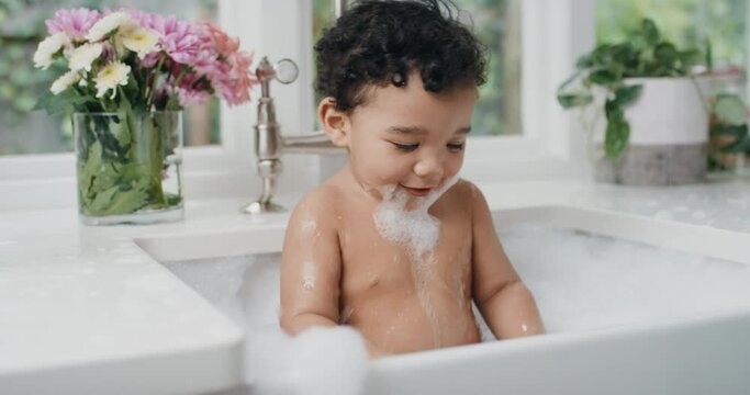 happy baby bathing funny toddler taking bath in kitchen sink having fun with soap bubbles 4k