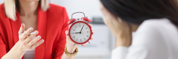 Manager shows alarm clock to subordinate, fixing delay for work - obrazy, fototapety, plakaty