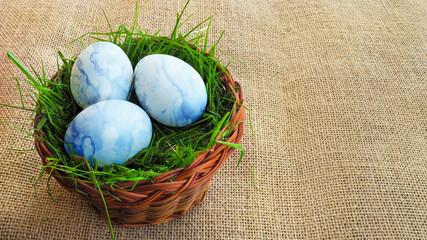 Basket with Easter eggs on a cloth.