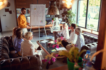 Obraz premium Group of business women listen to a male colleague presentation at workplace. Business, office, job