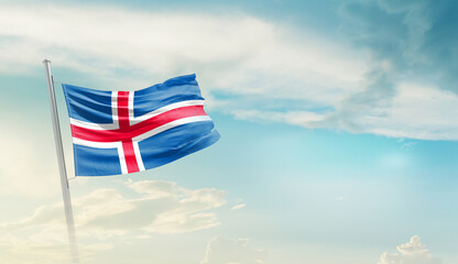 Iceland national flag cloth fabric waving on the sky - Image