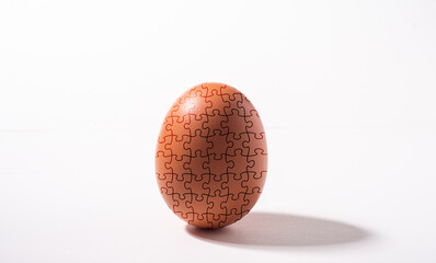 Egg with jigsaw design ,concept risk , danger or fragility  in business.