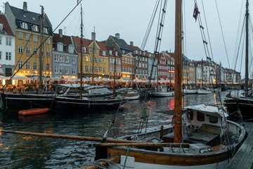 Copenhague, Denmark. September 28, 2019: Nyhavn promenade with colorful architecture and boats on the canal.