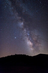 Fototapeta na wymiar Milky Way starry night sky over hills and trees Sardinia Italy