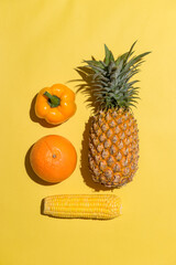 fresh various fruits on yellow background