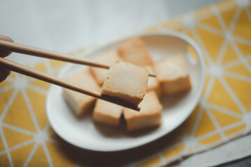 Fried fish tofu with chopstick. Hot pot ingredients