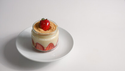 white background magnolia with strawberry on white plate