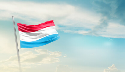 Luxembourg national flag cloth fabric waving on the sky - Image