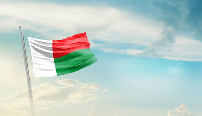 Madagascar national flag cloth fabric waving on the sky - Image