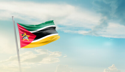 Mozambique national flag cloth fabric waving on the sky - Image