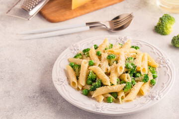 Pasta with green peas, broccoli and parmesan cheese.
