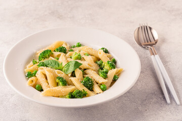 Pasta with green peas, broccoli and parmesan cheese.