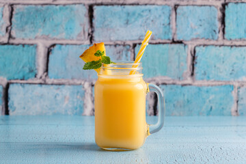 Tropical pineapple smoothie in a mason jar.