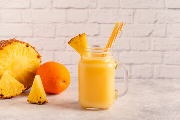 Tropical pineapple smoothie in a mason jar.