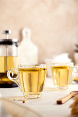 Herbal tea glass cups and teapot. Delicious healthy warm tea.