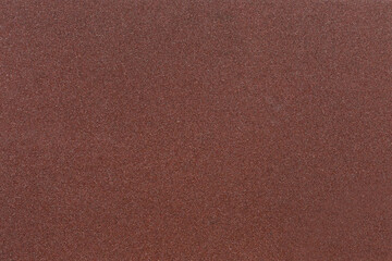 Red-brown sandpaper texture. Rough sandpaper background. Copy space.