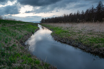 Uherka river in eastern Poland and cloudy sky