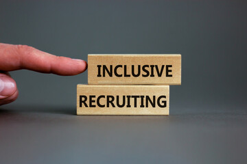 Inclusive recruiting symbol. Wooden blocks with words Inclusive recruiting on beautiful grey background. Businessman hand. Business, HR and inclusive recruiting concept. Copy space.