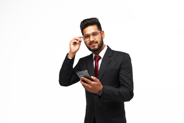 Portrait of young indian manager using his phone on white isolated background, looking to the camera