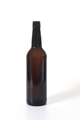 brown glass bottle of alcohol standing on white background