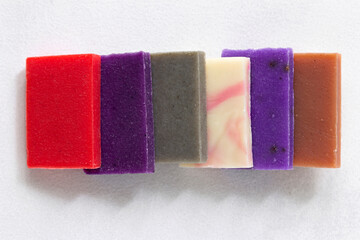 Variety of natural organic handcraft soap bars on white background.