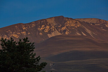 Fototapeta na wymiar Caucasian peaks in the rays of the rising sun.
