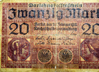 Large fragment of the obverse side of 20 twenty German marks banknote currency issued 1918 by Germany Reichsschuldenverwaltung in Berlin,   Note features Minerva and Mercury