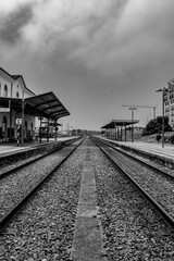 View of an old train line in São Martinho do Porto, Portugal. A nostalgic view of a train station in shades of white and black.