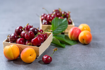 Naklejka na ściany i meble Small wooden boxes with fresh ripe sour kriek cherry berry