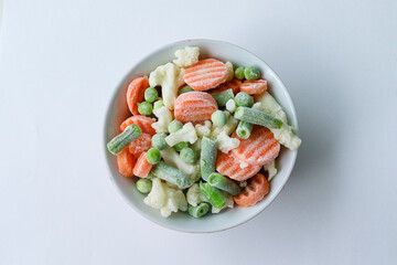 Frozen vegetables in a bowl - carrots, green beans, cauliflower and green peas