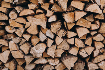 Natural wooden background - close up of chopped firewood. Firewood stacked and prepared for winter Pile of wood logs.