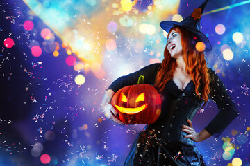 Halloween Witch Woman with long red hair and holiday make-up wearing dark tapered witch's hat